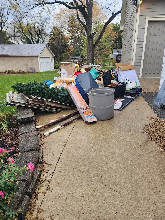 Dumpster being loaded with debris for Estate Cleanout Dumpster Rental in Grand Terrace